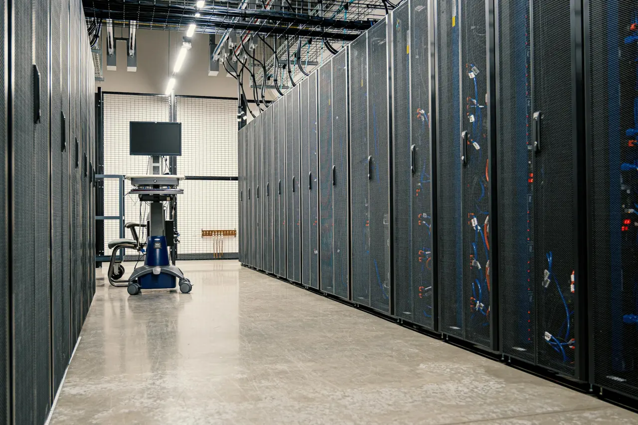 Long data-center corridor with server racks and controlled technical infrastructure, representing measurement depth and signal processing.
